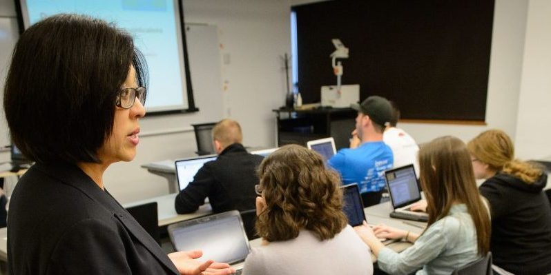 Fei Wang, associate clinical professor of pharmacy practice lectures at the Pharmacy/Biology Building on May 1, 2015. (Peter Morenus/UConn Photo)